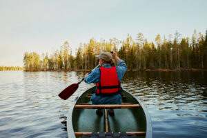 Canoeing on a wildernesslake in a summer evening
