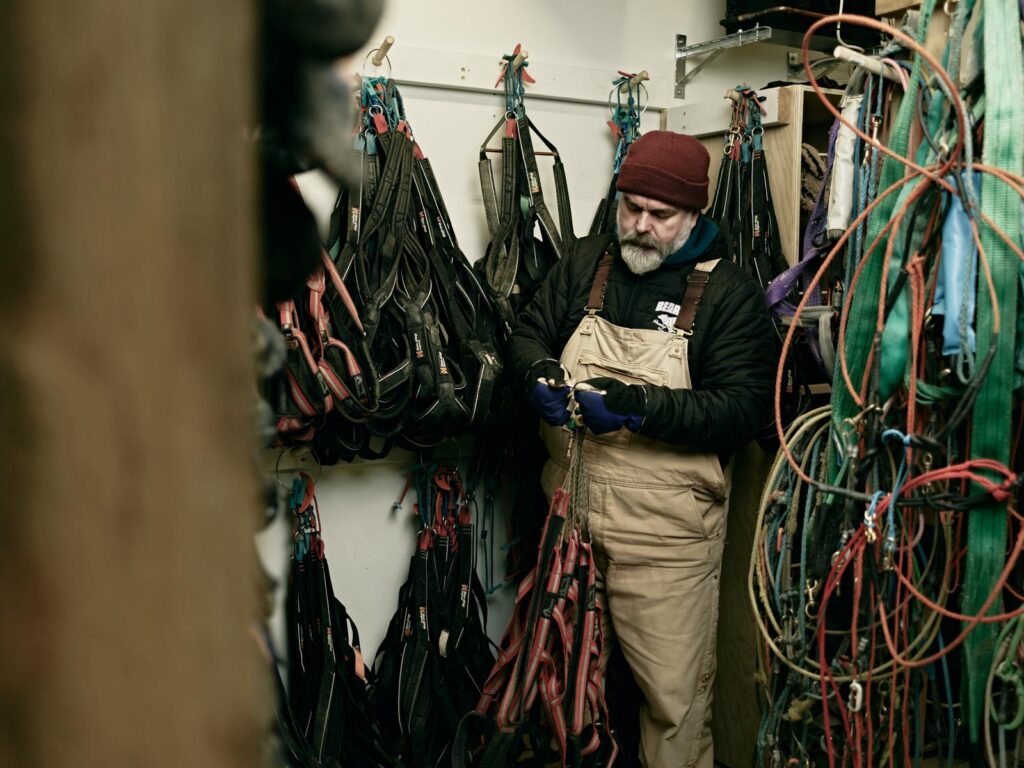 Valentijn checking harnesses in the drying room