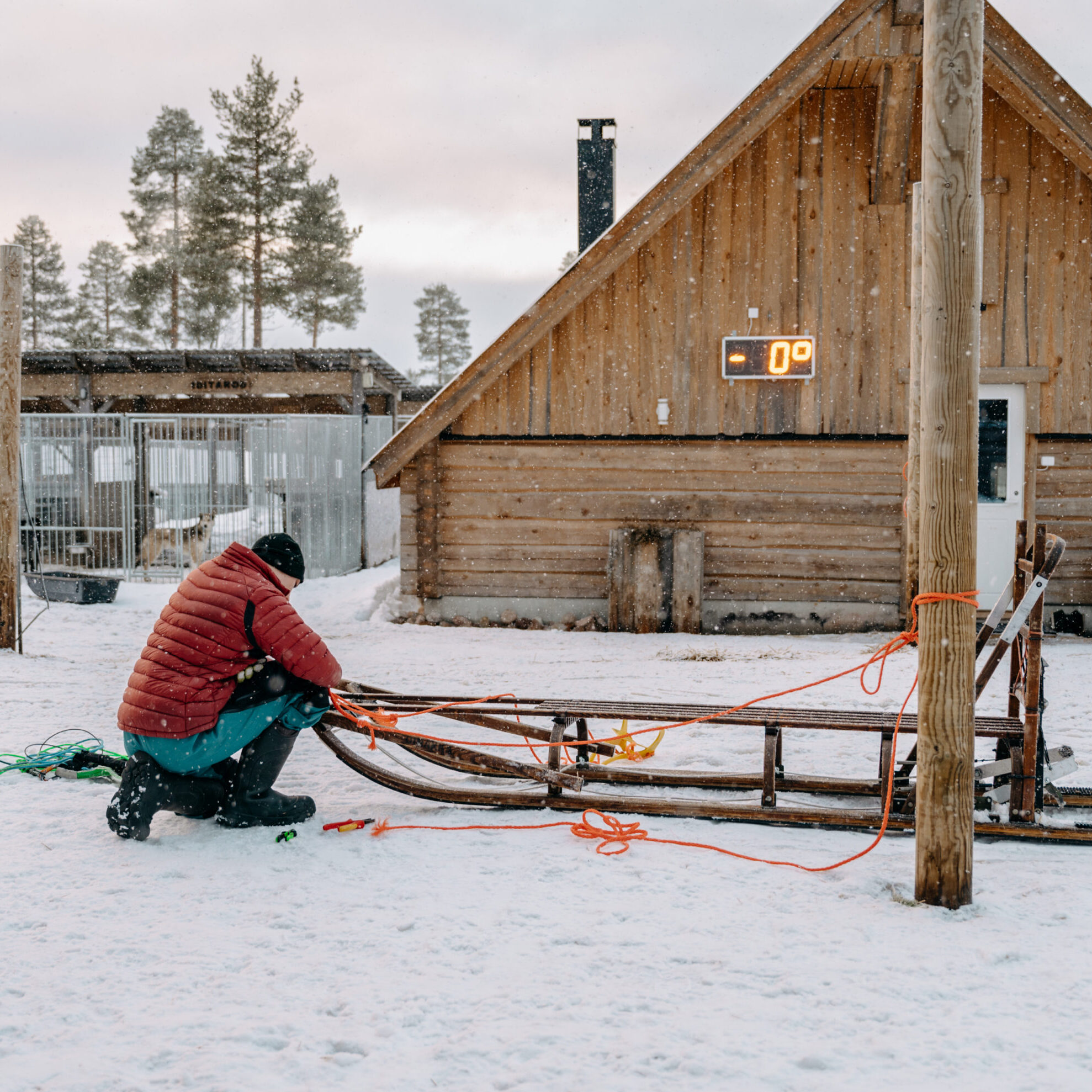 Staff member fixing a sled