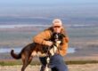 Jenna and her dog Peikko in front of a nice landscape view