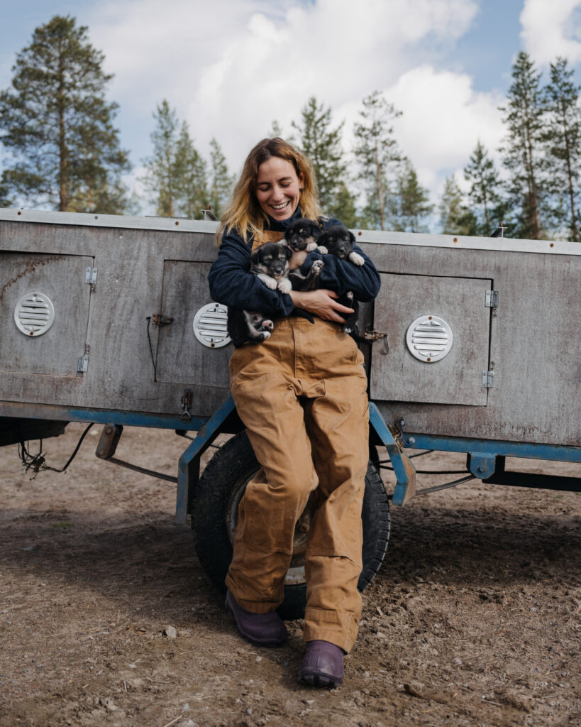 Bearhill Husky staff member holding 3 husky puppies in her arms
