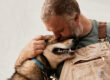 Alaskan Husky Kudu cuddling with Bearhill Husky owner Valentijn Beets