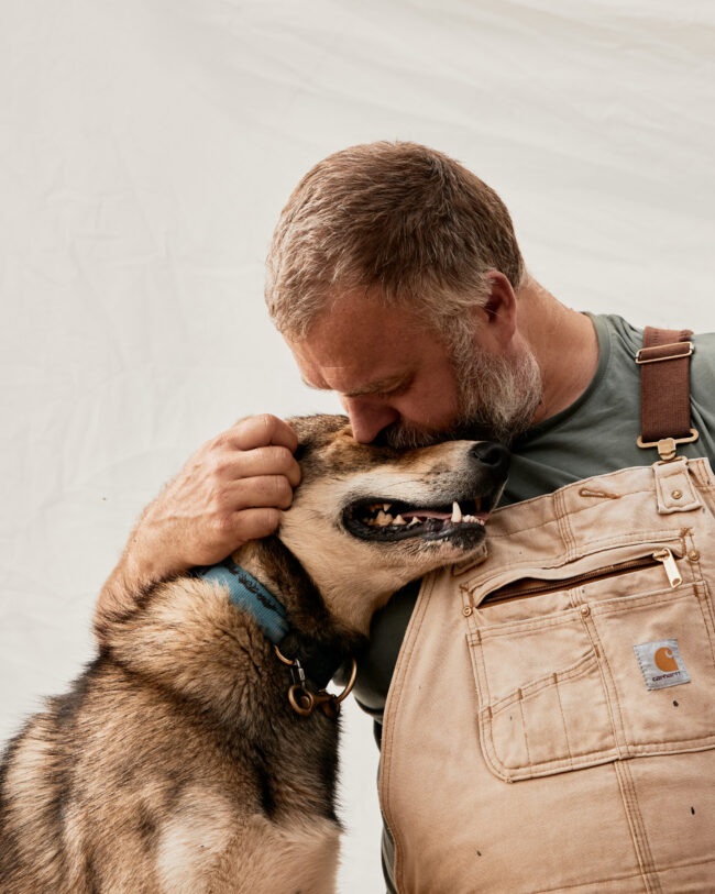 Alaskan Husky Kudu cuddling with Bearhill Husky owner Valentijn Beets